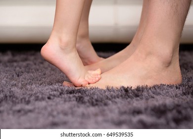 Little Daughter Standing on Tippy Toes on Father's Feet - Powered by Shutterstock