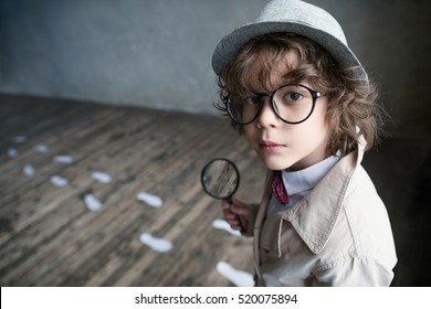 Little detective with a magnifying glass