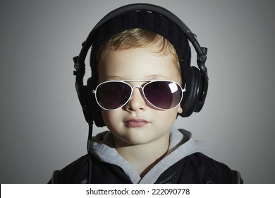 Little DJ. Funny Boy In Sunglasses And Headphones.child Listening Music. Deejay.gray Background