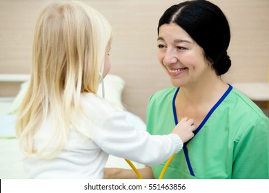 Little Doctor. Cheerful Senior Woman Doctor Laughing While Her Little Patient Is Playing With Her Stethoscope Healthcare Profession Job Work Happiness Care Help Experience Trust Love Kids Concept 