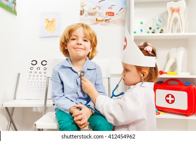 Little doctor examining boy with stethoscope