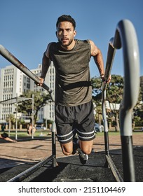 A Little Effort Goes A Long Way. Shot Of A Muscular Young Man Exercising At A Calisthenics Park.