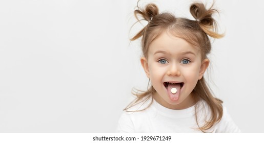 Little Emotional Adorible Child With Pill,candy,dragee On Tongue. Taking Medicine, Vitamin Supplements,nutrition,healt Care, Treatment Concept. Complete Multivitamin, Mineral Formula. Banner,mock Up