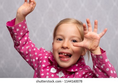 little european girl smiling rejoices fooling gesticulating hands portrait