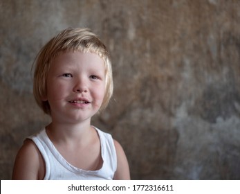 Little Fair-haired Boy Is Smeared With Blood. Baby Has Weak Vessels In Nose Bursting With Pressure Drops And Changes In Weather. Hemophilia Disease. Blond Child Lifts His Head To Stop The Bleeding