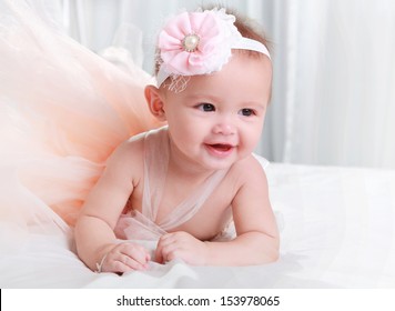 Little fairy; sweet ballerina with fluffy pink skirt and flower