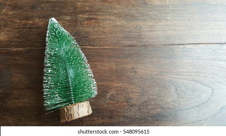 Little Fake Christmas Tree On Wood Wall.