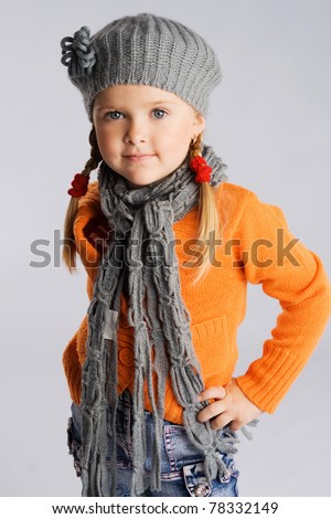 Little fashionable girl in warm clothes