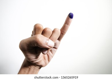 The Little Finger Of A Man's Hand With Blue Ink Patches Isolated On A White Background. Blue Ink Spots From The Fingers Of Indonesia's Presidential Election (presidential Election).
