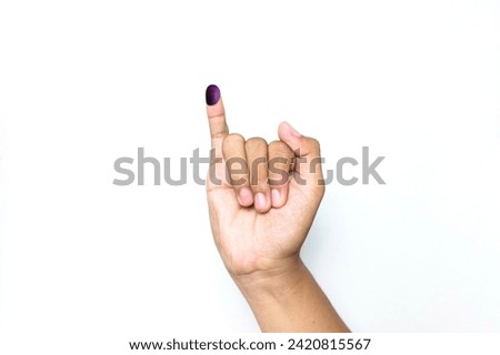 The little finger of a man's hand with blue ink patches isolated on a white background. blue ink spots from the fingers of Indonesia's presidential election (presidential election).