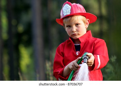 little fire man in the garden with the water hose
