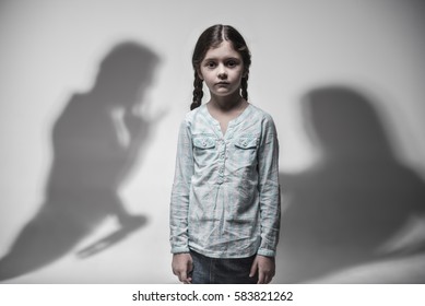 Little frustrated girl holding her arms at side - Shutterstock ID 583821262