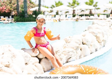 Little fun girl is in swimming pool