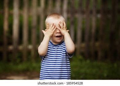 little funny boy plays hide and seek