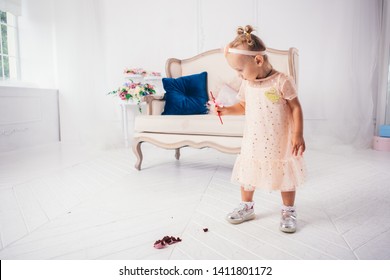 Little Funny Caucasian Child Girl Dropped On The Floor Sweetness Dessert Cake And Mess. Kindergarten And Birthday Party Spoiled, Fell Sweet Food On The Floor At Home.