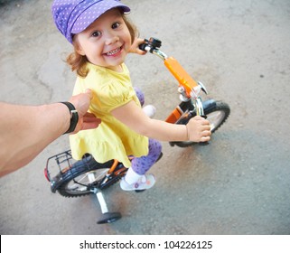 Little Funny Girl Learning To Ride A Bike