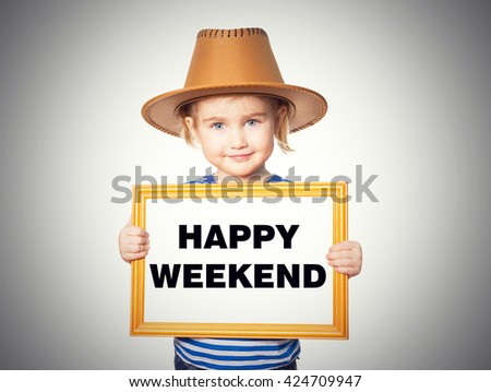 Little Funny girl in striped shirt with blackboard. Text HAPPY WEEKEND Isolated on gray background.