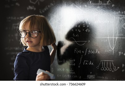 Little genius drawing up some science - Shutterstock ID 736624609