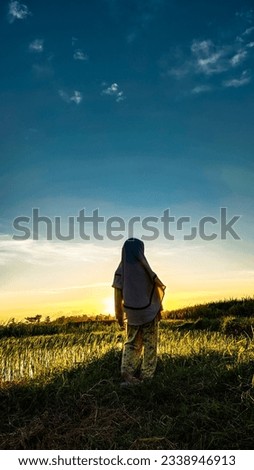 Similar – Sonnenuntergang, Rückenansicht Frau, Feld