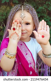 A Little Girl Of 4 Years Old Indian In Sarri With A Red Dot Makes A Hand Movement Showing Her Palm On March 8 In The Spring. Pink Sari