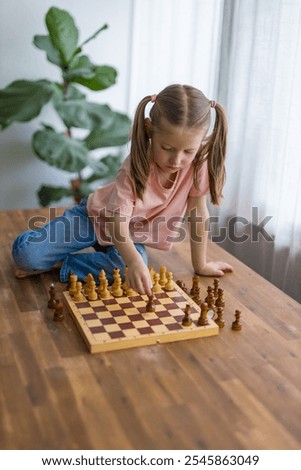 Similar – Image, Stock Photo lifestyle shot of smart kid girl playing checkers at home