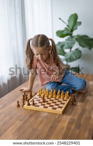 Similar – lifestyle shot of smart kid girl playing checkers at home