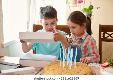 Little girl 5 years old sister standing near her brother opening white blank mockup box with happy surprise inside it. Celebrating birthday event. Birthday present. Gifts. People. Lifestyle. Childhood - Shutterstock ID 2311628869