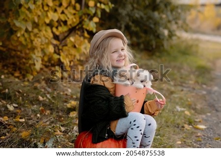 Similar – Foto Bild Herbstporträt eines glücklichen Kindes Mädchens, das mit ihrem Hund spielt.