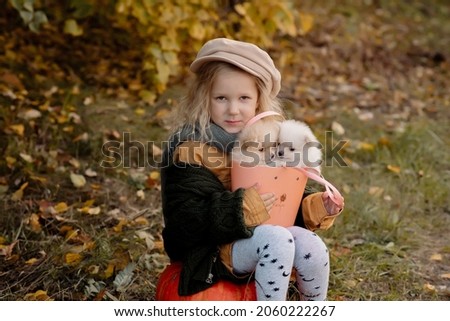 Similar – Foto Bild Herbstporträt eines glücklichen Kindes Mädchens, das mit ihrem Hund spielt.