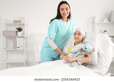 Little girl after chemotherapy with yellow ribbon and nurse in clinic. Childhood cancer awareness concept - Powered by Shutterstock