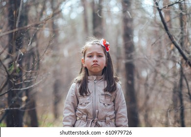 A Little Girl Alone In The Woods. The Girl Is Calling For Help. The Child Was Lost In The Woods