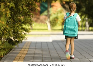 Little girl with backpack going to school, back view. Space for text - Powered by Shutterstock