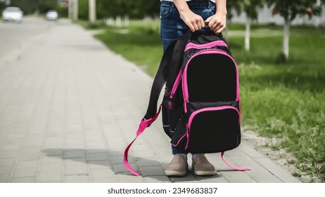 Little girl with backpack going to school, back view. Back to school. copy space