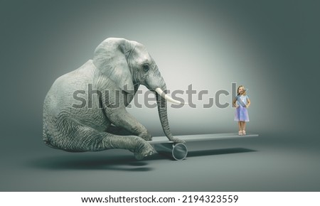 Little girl balancing on a plank with a big elephant