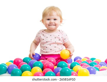 Little girl in ball pit with colored balls isolated
