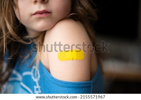 Little girl with a band-aid on her hands, vaccinated against coronavirus infection. Vaccination against COVID-19. Copyspace. High resolution banner. High quality photo Сток-фото © 