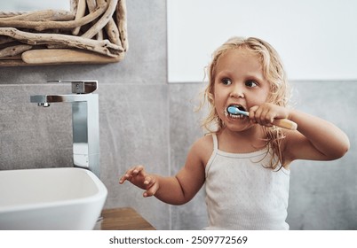 Little girl, bathroom and cleaning teeth with toothbrush for dental care, hygiene or morning routine at home. Young female person, child or kid with brush for oral, mouth or clean gums at house - Powered by Shutterstock