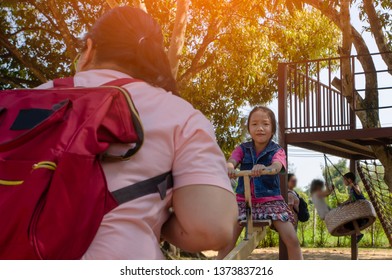 Little girl be exciting on teeter board with her mom