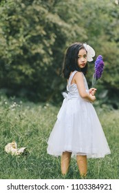 Little girl in a beautiful dress in a garden at sunset in Hanoi, Vietnam.