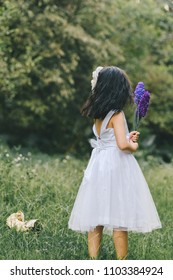 Little girl in a beautiful dress in a garden at sunset in Hanoi, Vietnam.