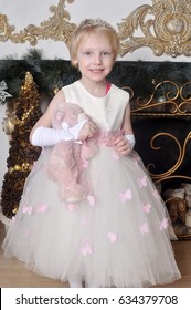 A little girl in a beautiful white dress - Shutterstock ID 634379708