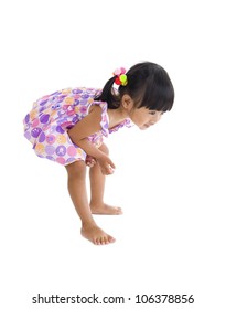 Little Girl Bending Over To Have A Closer Look At Something