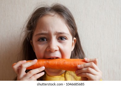 Little girl with a big carrot