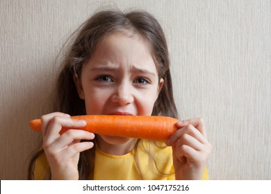 Little girl with a big carrot