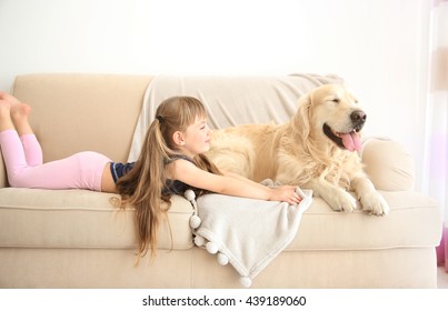 Little Girl And Big Kind Dog On Sofa