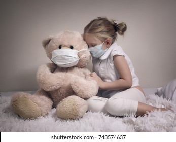 Little Girl And Big Plush Bear In Medical Masks. The Concept Of Childhood Diseases, Empathy, Support And Help Sick Children