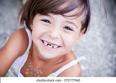 Little Girl With Big Smile And Missing Milk Teeth