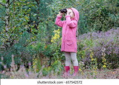 Little Girl With Binoculars Birdwatching In Summer Forest