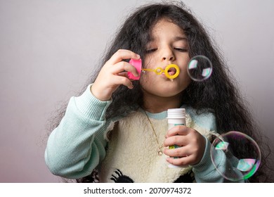 Little Girl Blowing Air In To Plastic Bubble Maker, Playing And Leisure Time Activity For Children