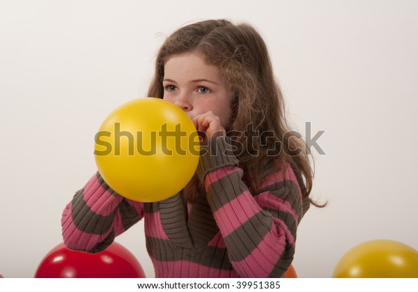 Little Girl Blowing Balloon Stock Photo (Edit Now) 39951385